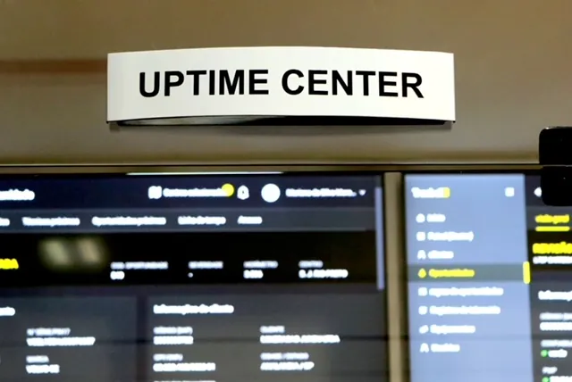 Uptime Center sign above the monitoring screens.